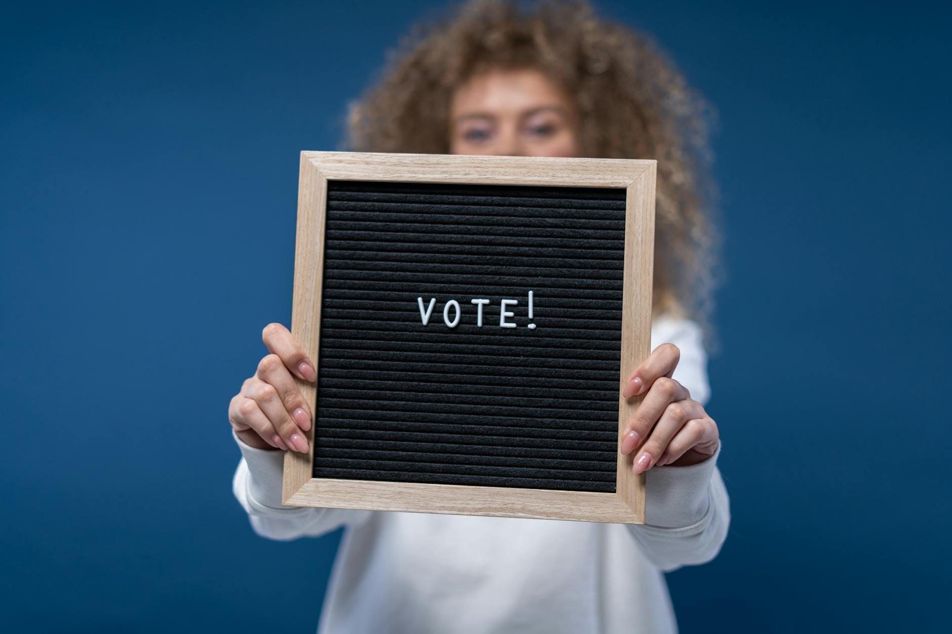 person holding a vote sign