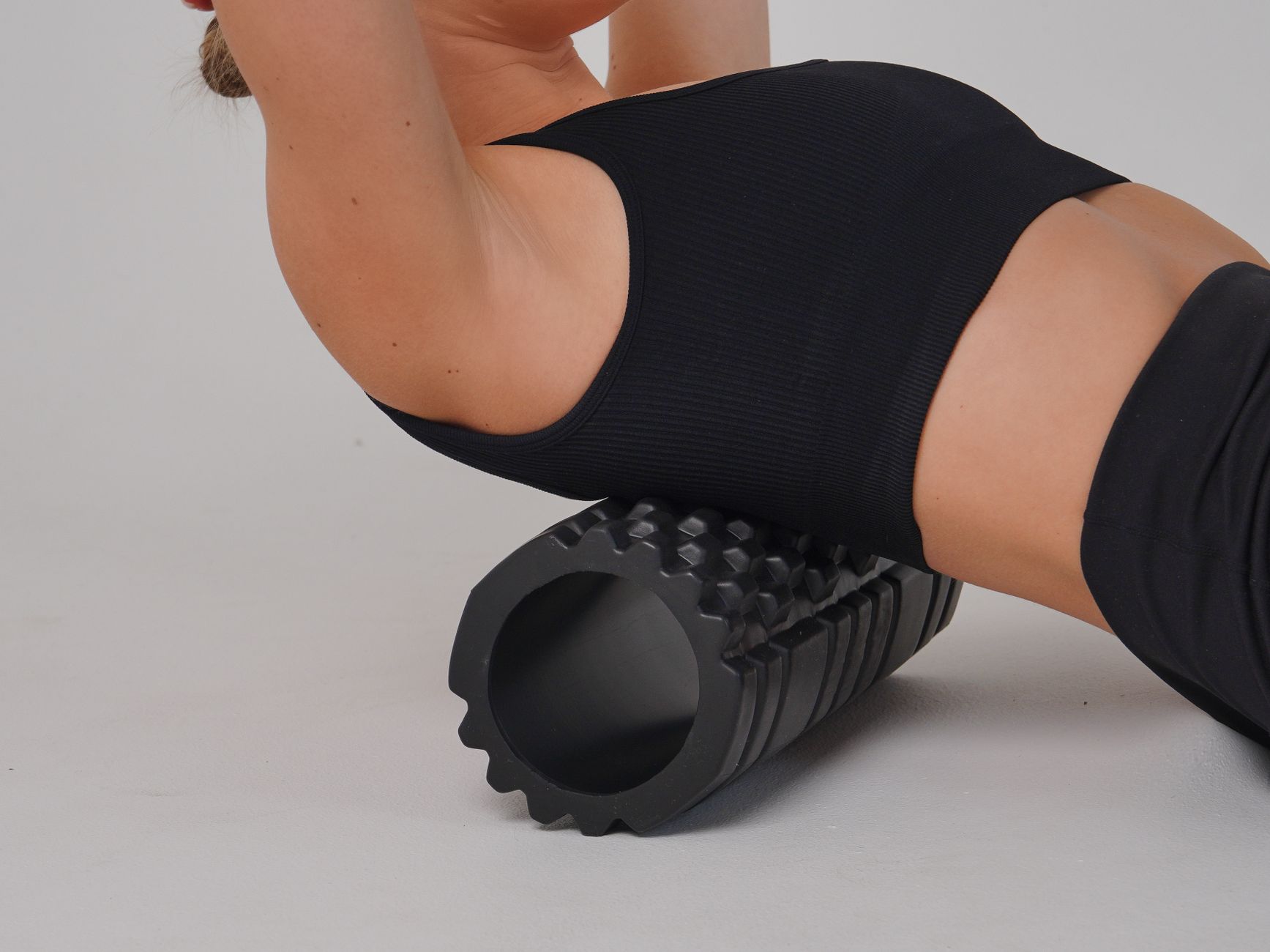 woman stretching back on roller