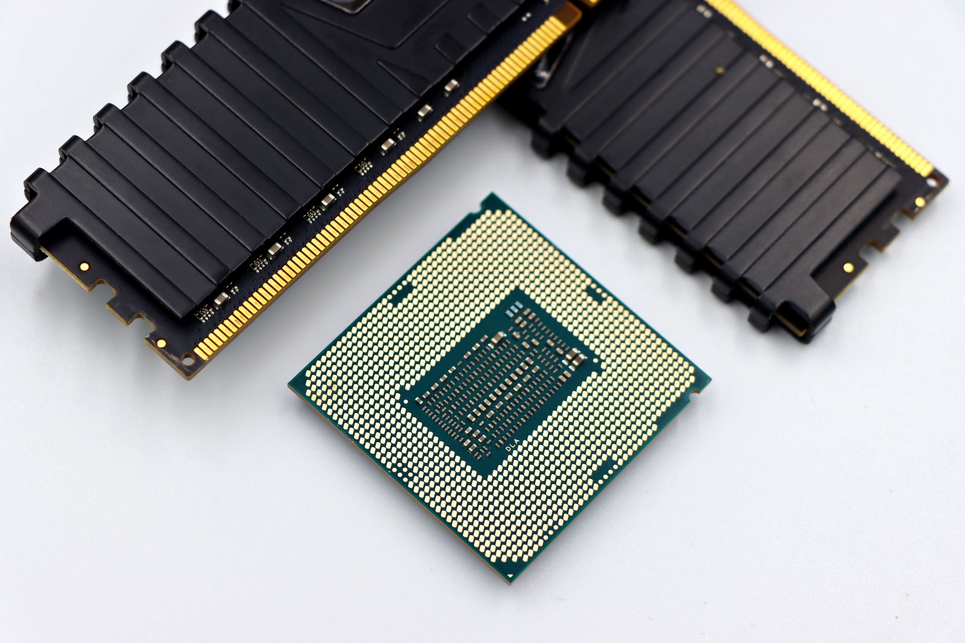 close up of cpu and ram sticks on white background